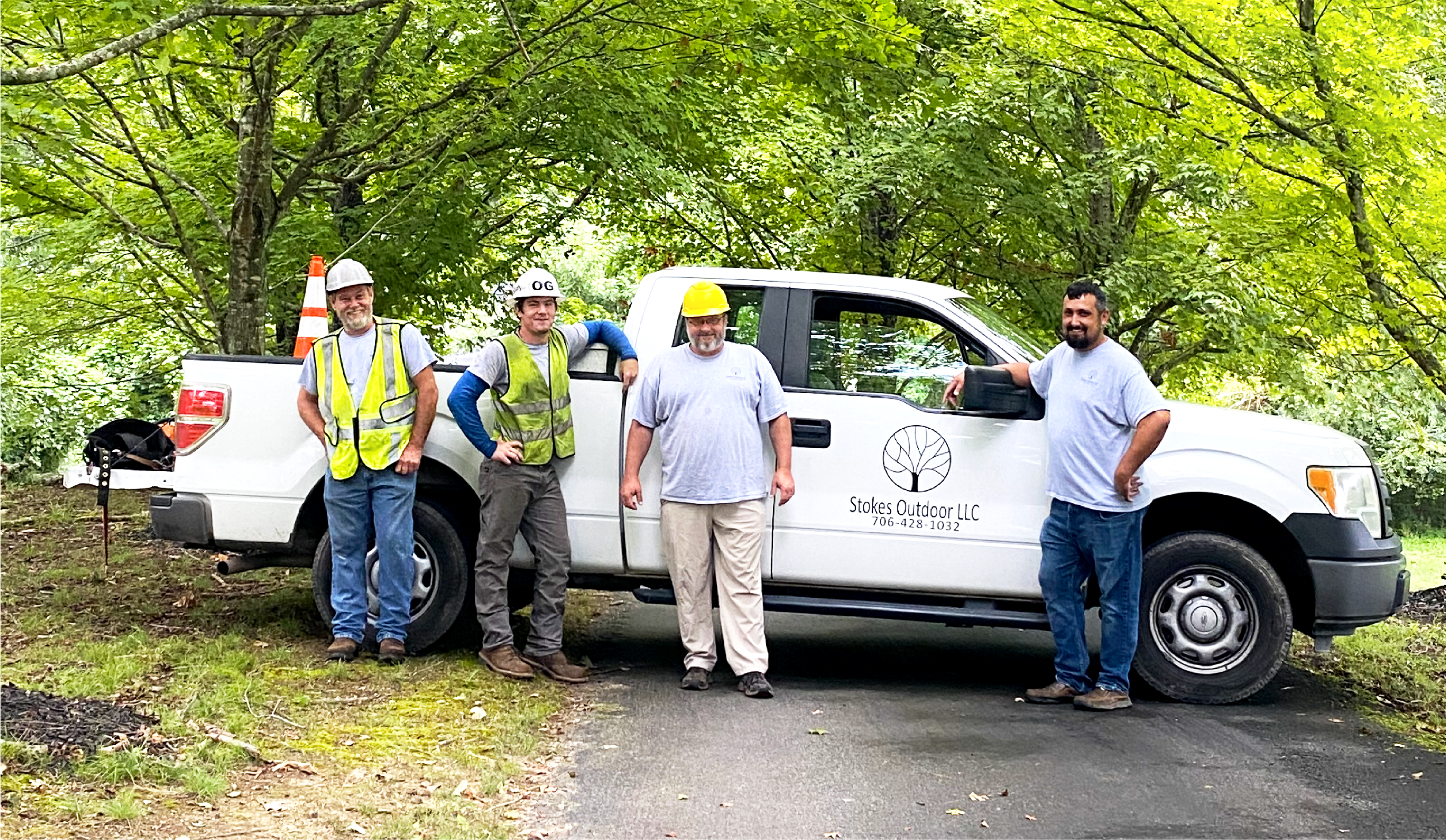 Stokes Outdoor and Tree Service team in front of company truck